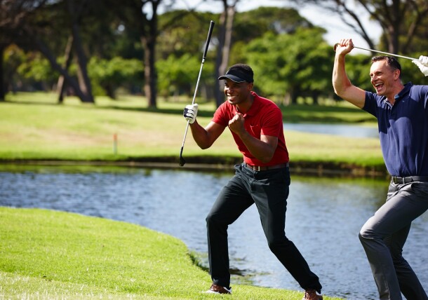 Golfers celebrating on golf course fairway